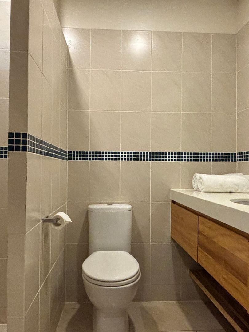 Modern bathroom with shower, toilet, and wooden vanity at Warwick Le Lagon - Vanuatu in Efate.
