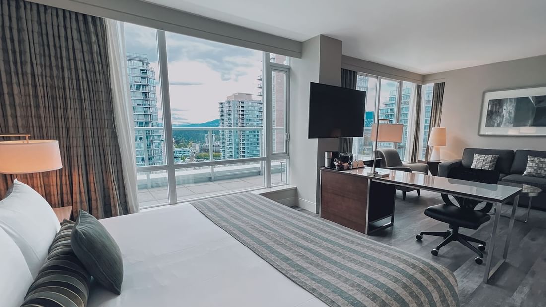 Premium King bedroom with view, couch, tv, and balcony