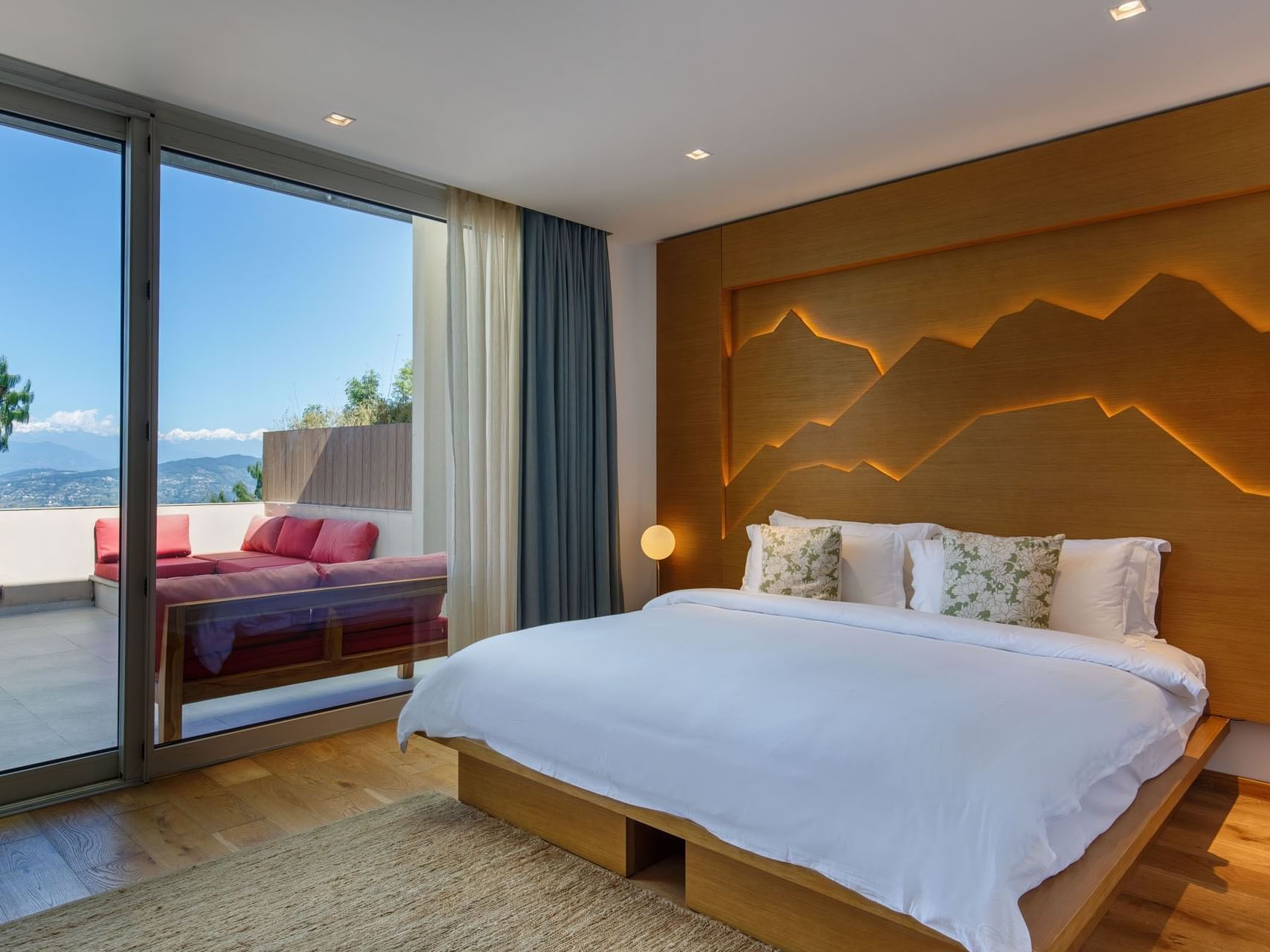 Deluxe Suites with mountain art on the wall, and terrace overlooking hills at The Terraces Resort & Spa