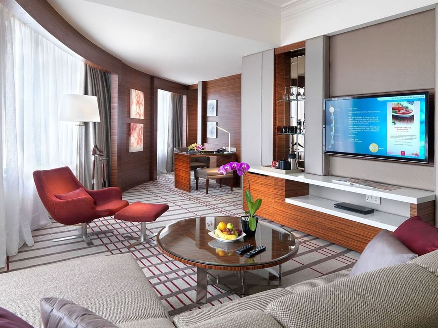 Modern living room with lavish interior & decor in Junior Suit with carpeted floors, A One World Hotel room