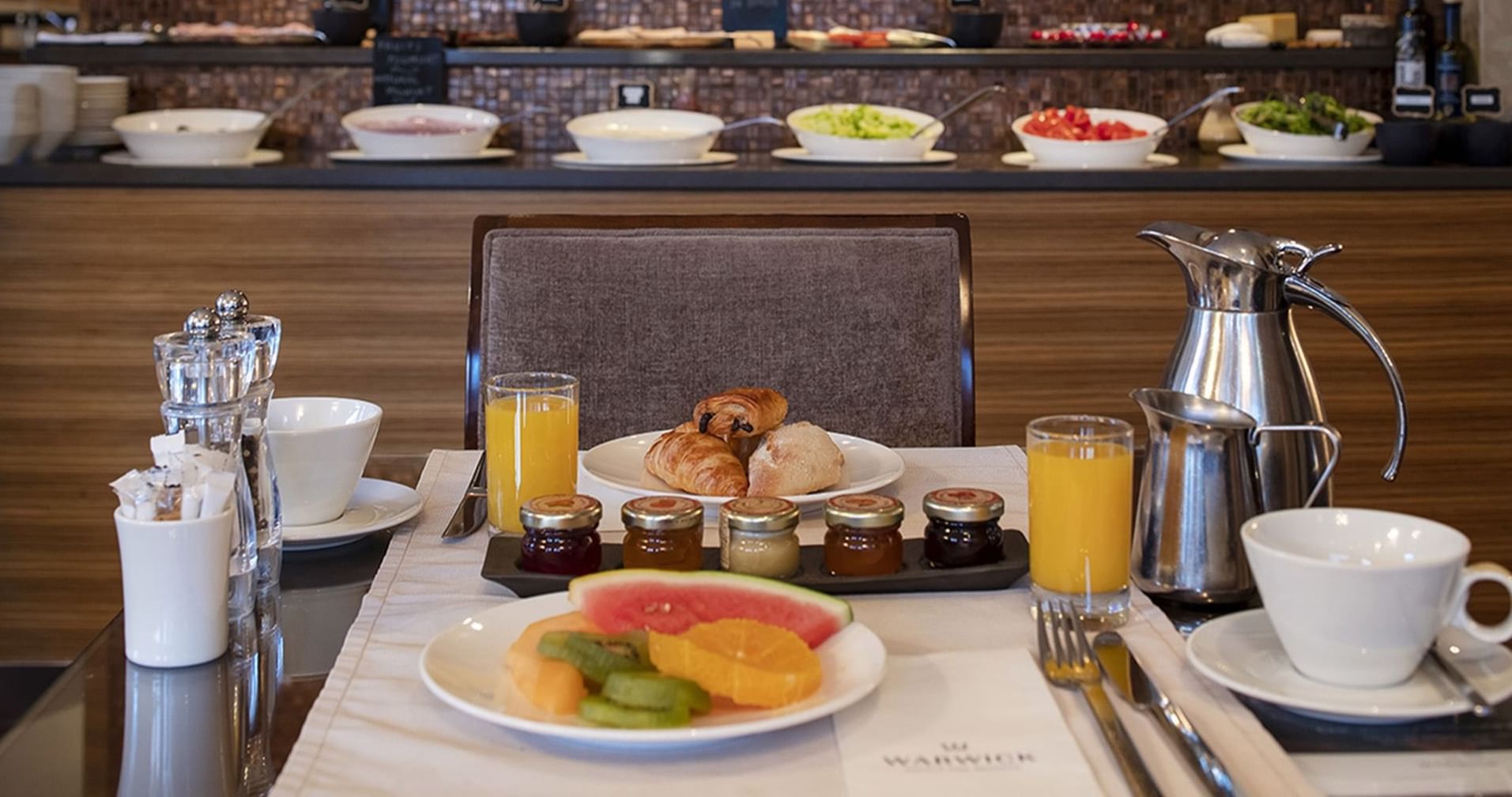 Close-up of breakfast served with juice at Warwick Geneva