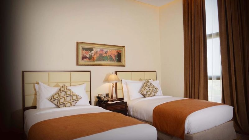 Cozy bedroom with double beds in Ambassador Suite at Warwick Al Khobar