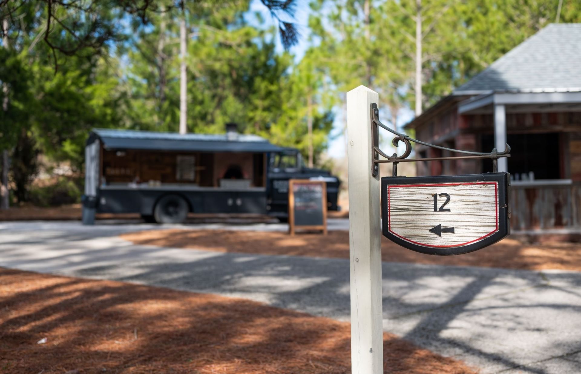 Sign number 12 pointing to a food truck at Camp Creek Inn