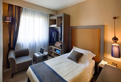 Bed & furniture in Single Room at Hotel Mozart in Milan