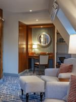 Junior Suite TV lounge area featuring a sofa near the working desk at Warwick Grand Place Brussels