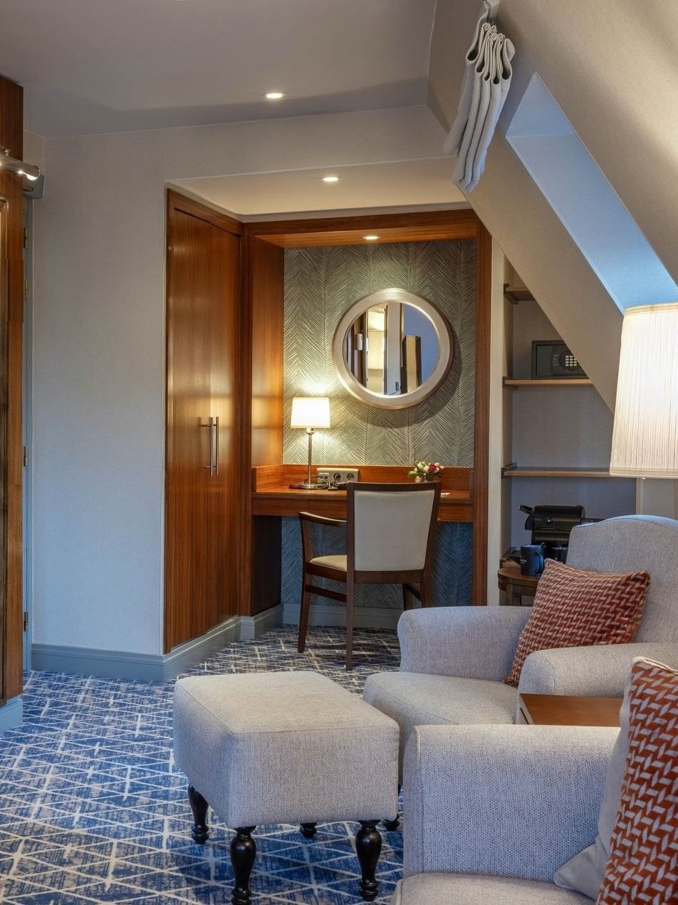 Junior Suite TV lounge area featuring a sofa near the working desk at Warwick Grand Place Brussels