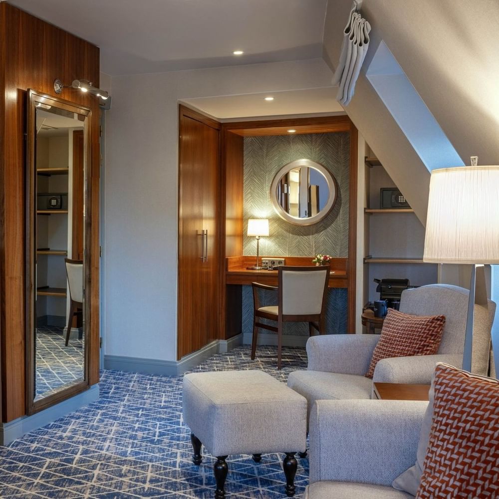 Junior Suite TV lounge area featuring a sofa near the working desk at Warwick Grand Place Brussels