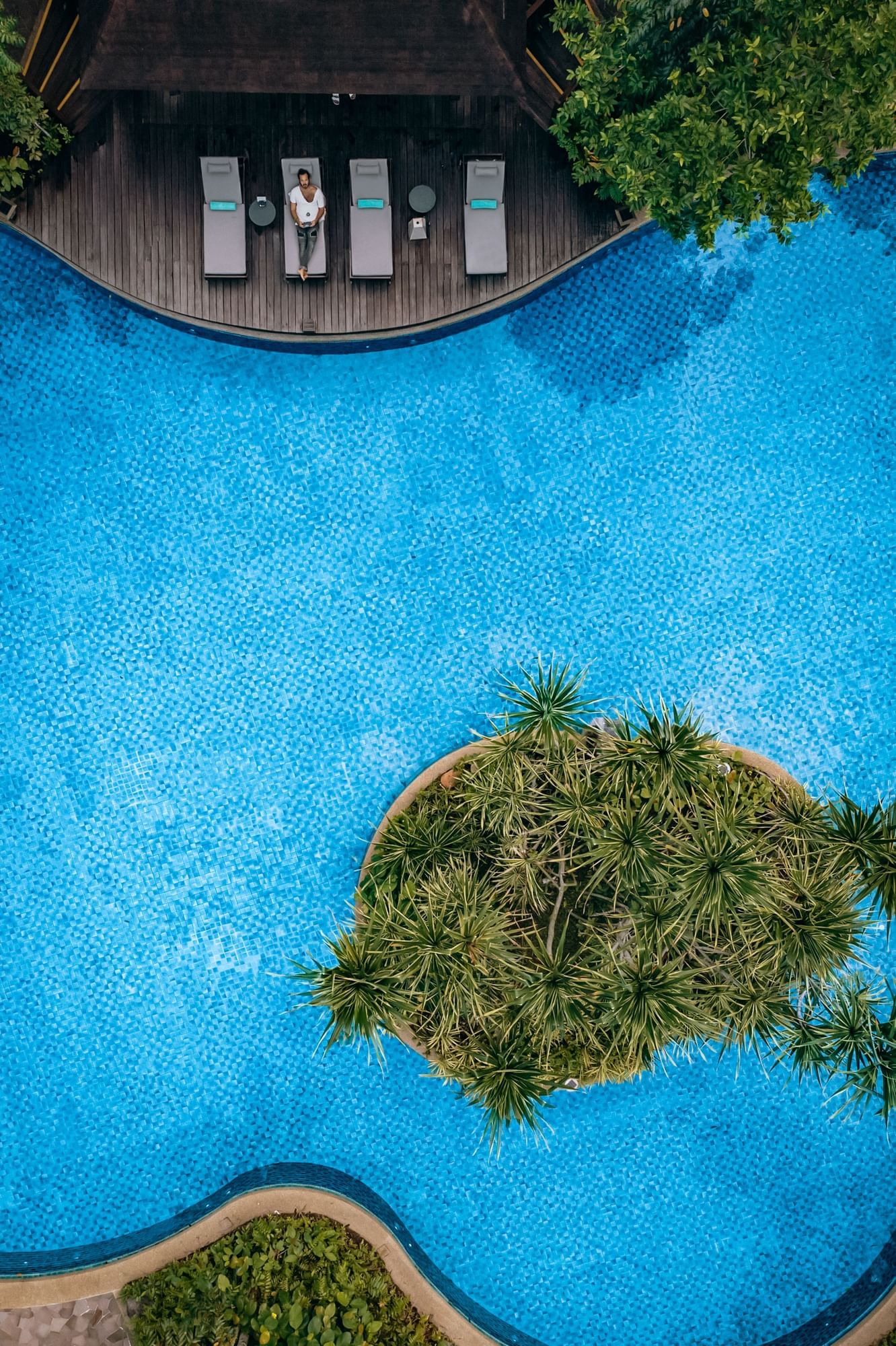 Aerial view of The Banjaran Hotsprings Retreat swimming pool with pool lounge chairs