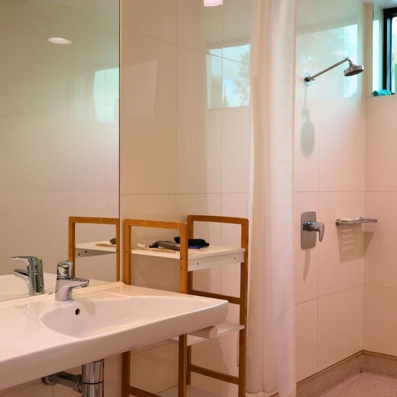 Clean white bathroom with sink and shower at La Trobe University - McFarlane's Hill Residences.
