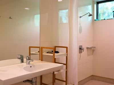 Clean white bathroom with sink and shower at La Trobe University - McFarlane's Hill Residences.