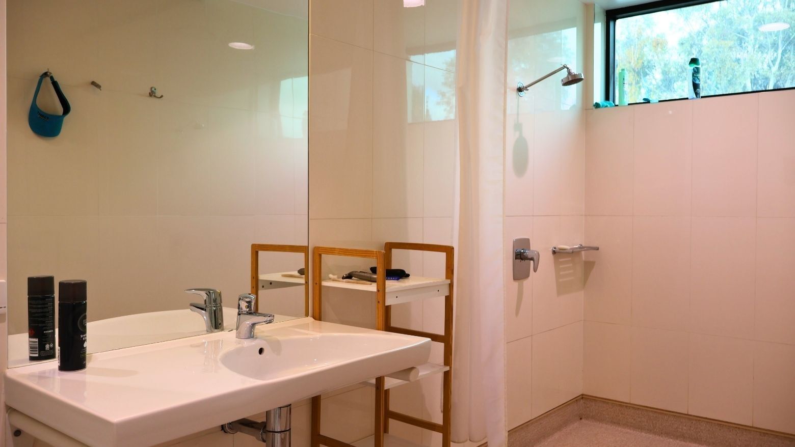 Clean white bathroom with sink and shower at La Trobe University - McFarlane's Hill Residences.