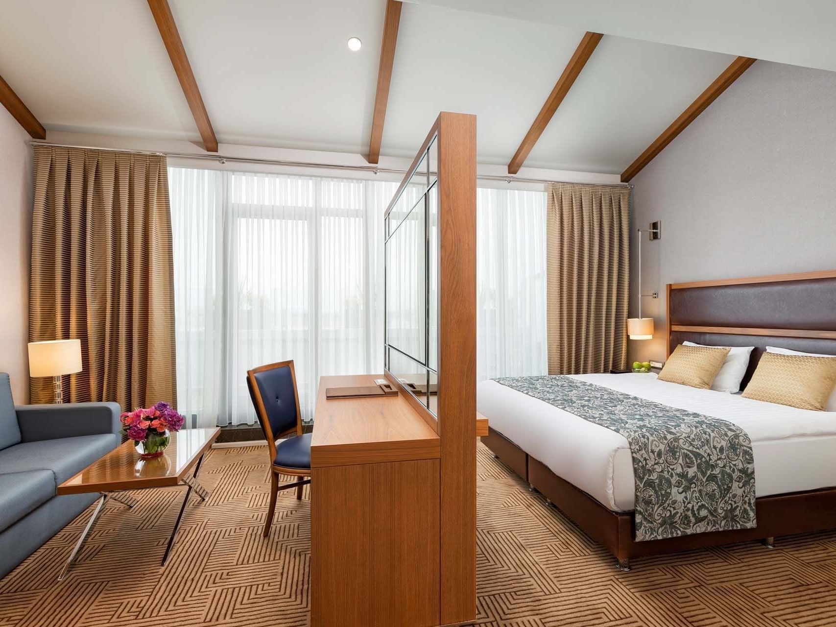 Lounge area with a TV by the bedroom at Titanic City Taksim