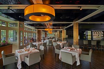 Ti Chen’s elegant interior with glowing round lights, set tables, and a sleek bar at The Saujana Hotel Kuala Lumpur