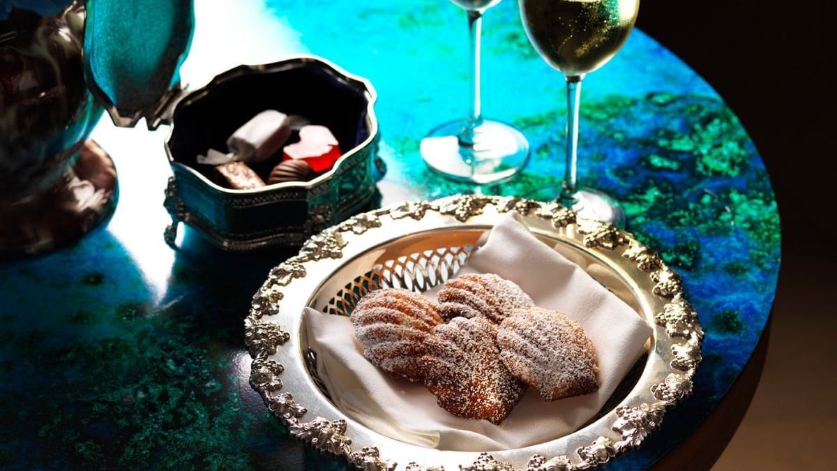 Elegant dessert setup with pastries, chocolates, and champagne served in Icebergs Harbour Bar at Crown Hotels