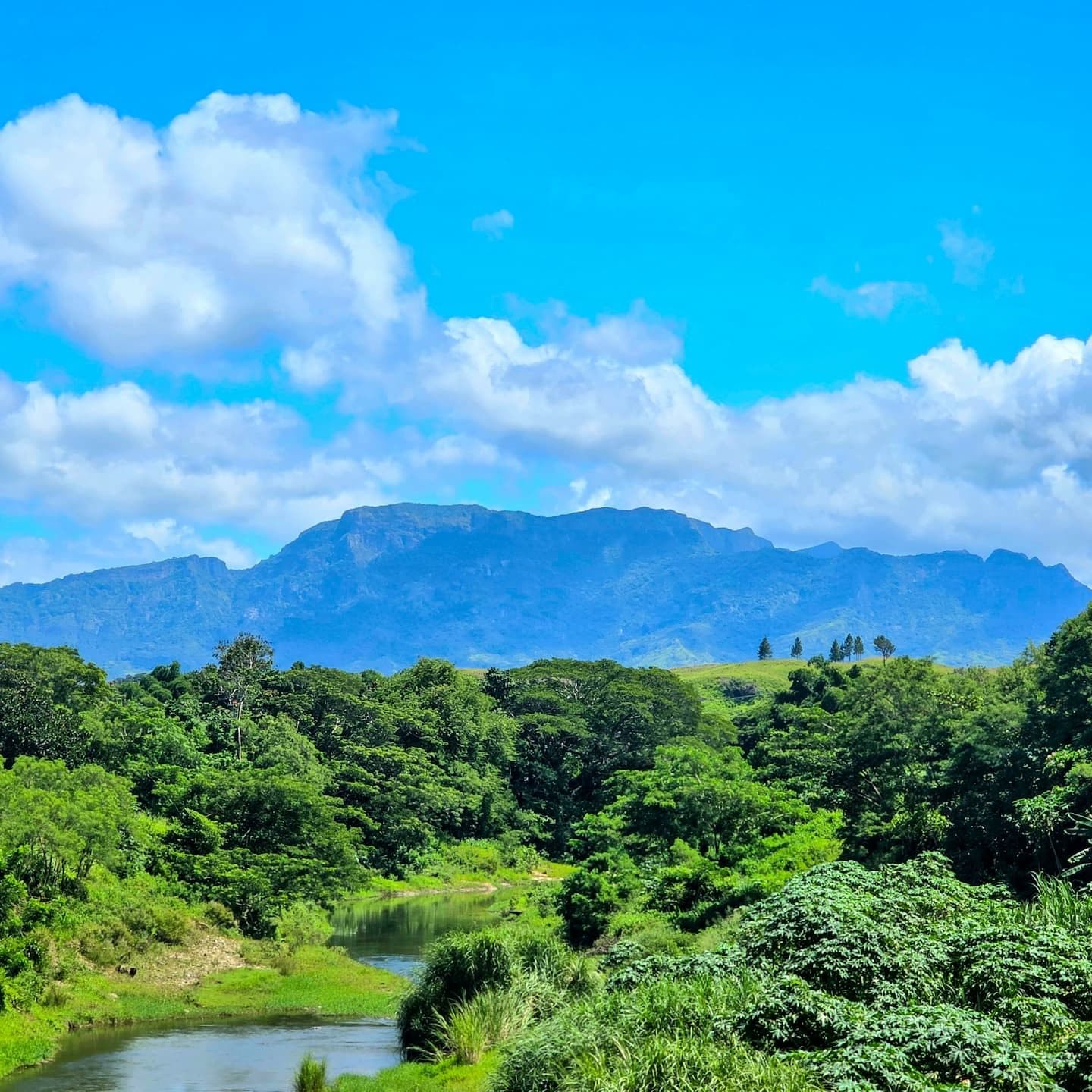 Lush green valley with a river and mountains in the Garden of the Sleeping Giant near TokaToka Resort Nadi Fiji