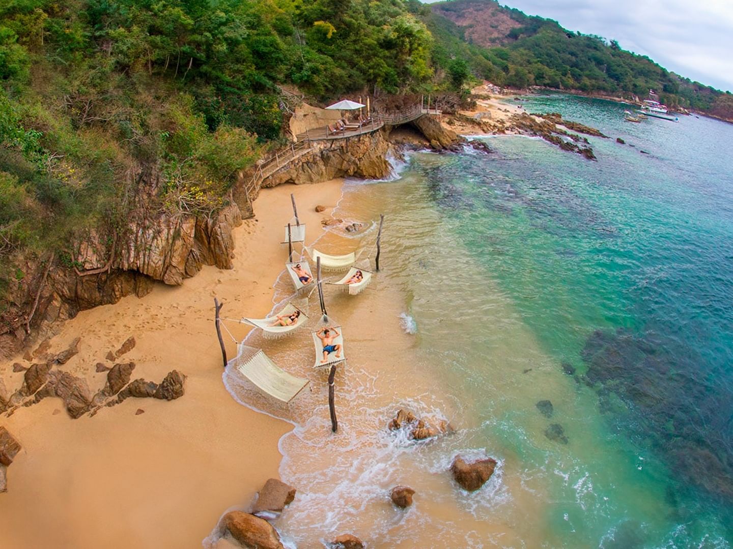 People enjoying hammocks on Las Caletas Cabo Corrientes beach near Plaza Pelicanos Club Beach Resort