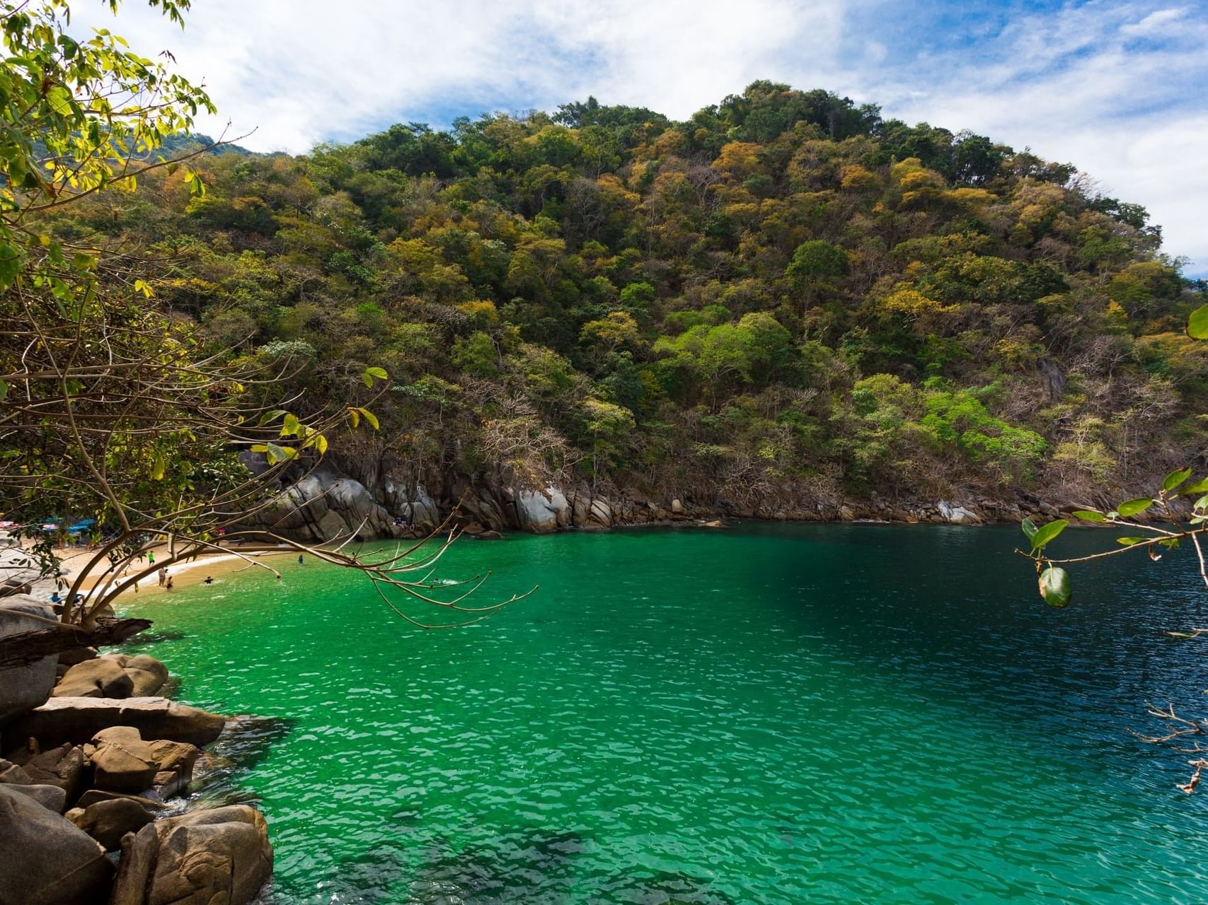 Colomitos Beach with green sea and a rocky coast near Plaza Pelicanos Grand Beach Resort