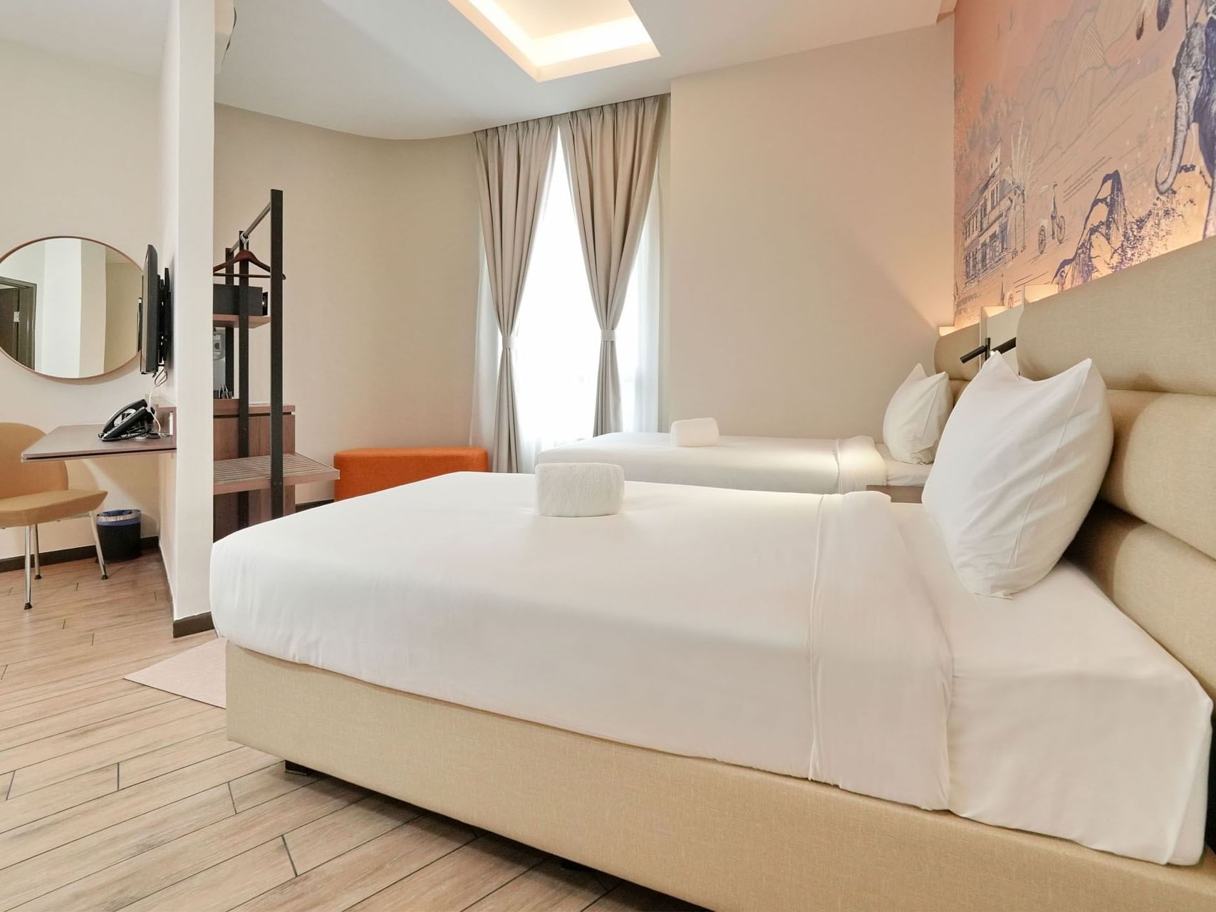 TV, mural and workspace by the beds in Family Quad with wooden floors at Cititel Express Ipoh