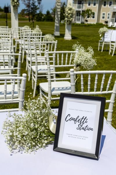 Confetti station sign with white flowers, ideal for a pei wedding location setup at Rodd Crowbush Resort