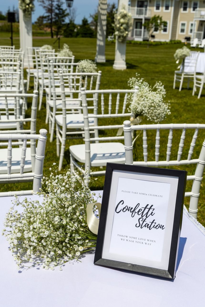 Confetti station sign with white flowers, ideal for a pei wedding location setup at Rodd Crowbush Resort