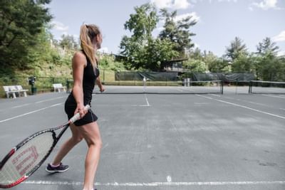 Two people playing tennis at Topnotch Stowe Resort