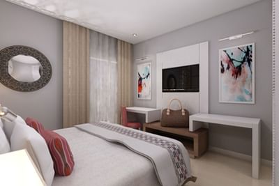 Large bed, work desk & TV in a room at Azalai Hotel Dakar