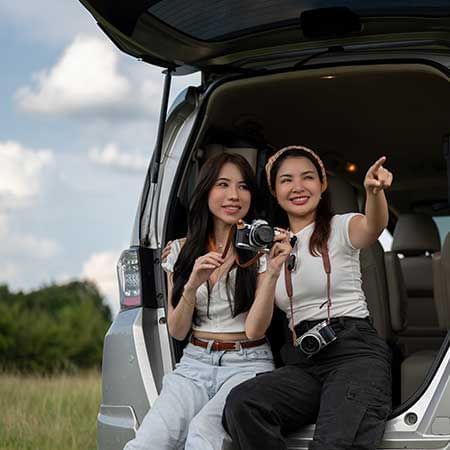 Two women were sitting on the car boot and taking pictures - Lexis Suites Penang