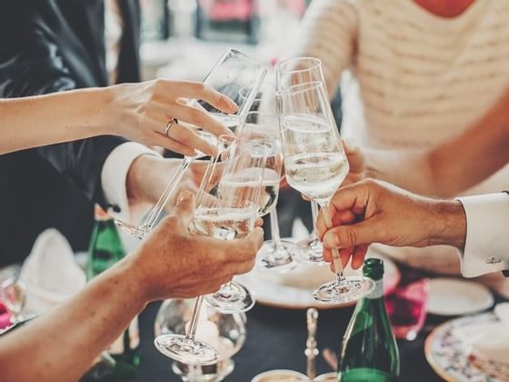 People toasting their wine glasses at The Magnolia Hotel