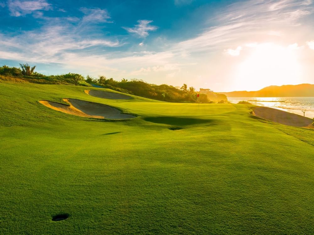 Golf Course lit by golden sunlight near La Colección Resorts