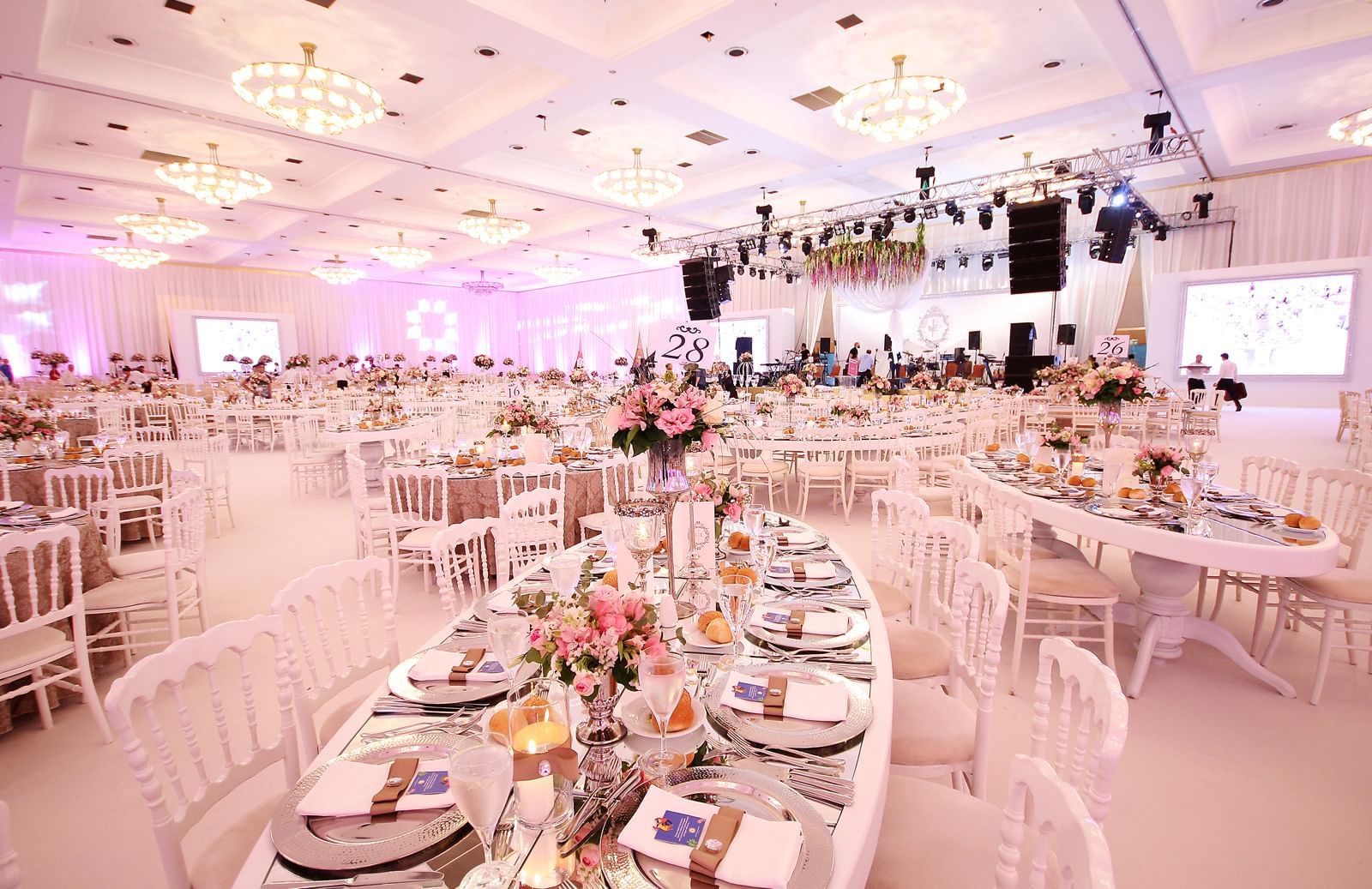 Wedding hall with oval shape tables at Wow Hotels Group 
