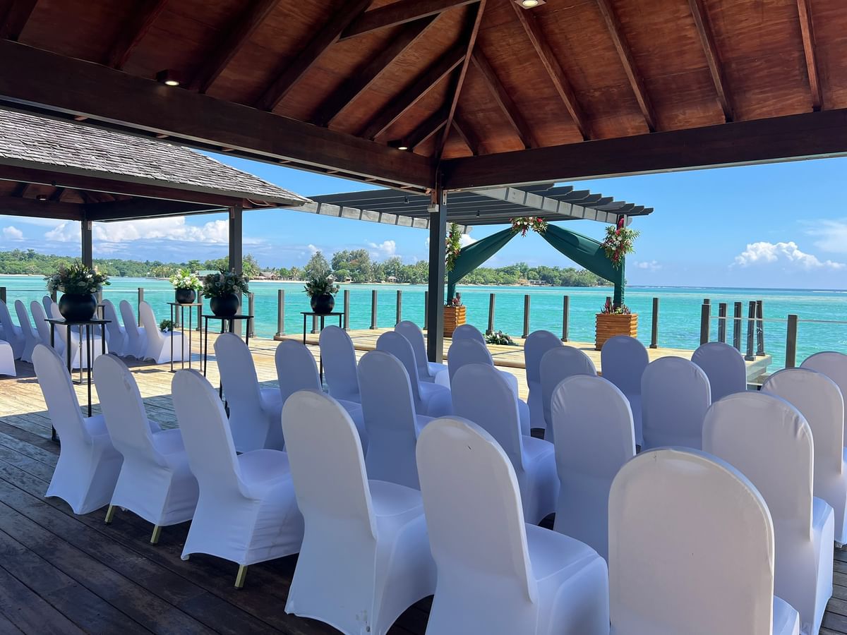 Chairs arranged for an event on a wooden deck overlooking the ocean at Warwick Le Lagon - Vanuatu Port Vila