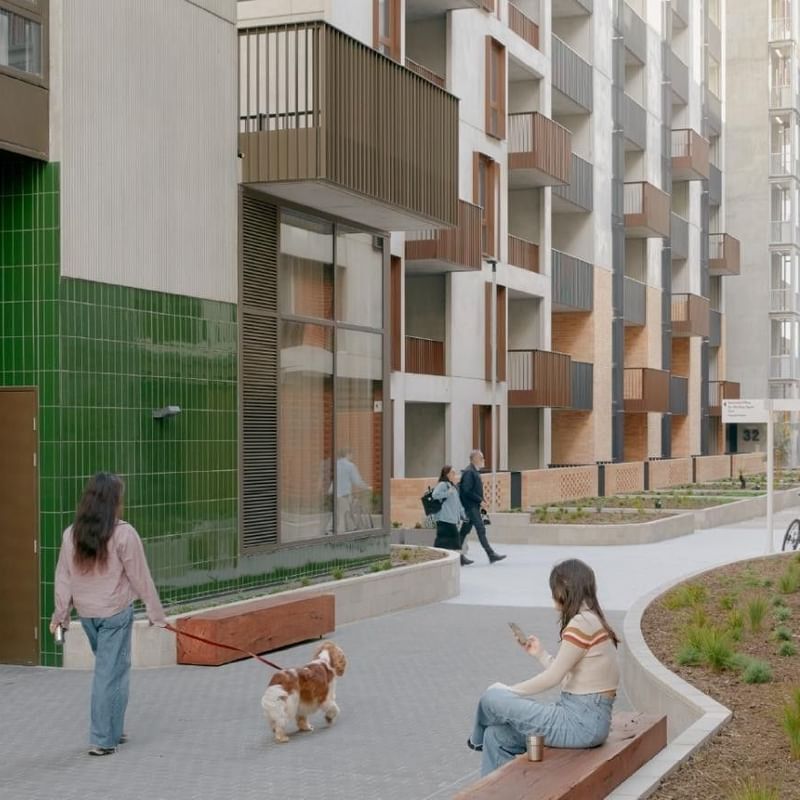Exterior image of Swift Walk apartment building with people and a dog walking.