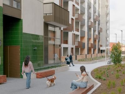 Exterior image of Swift Walk apartment building with people and a dog walking.