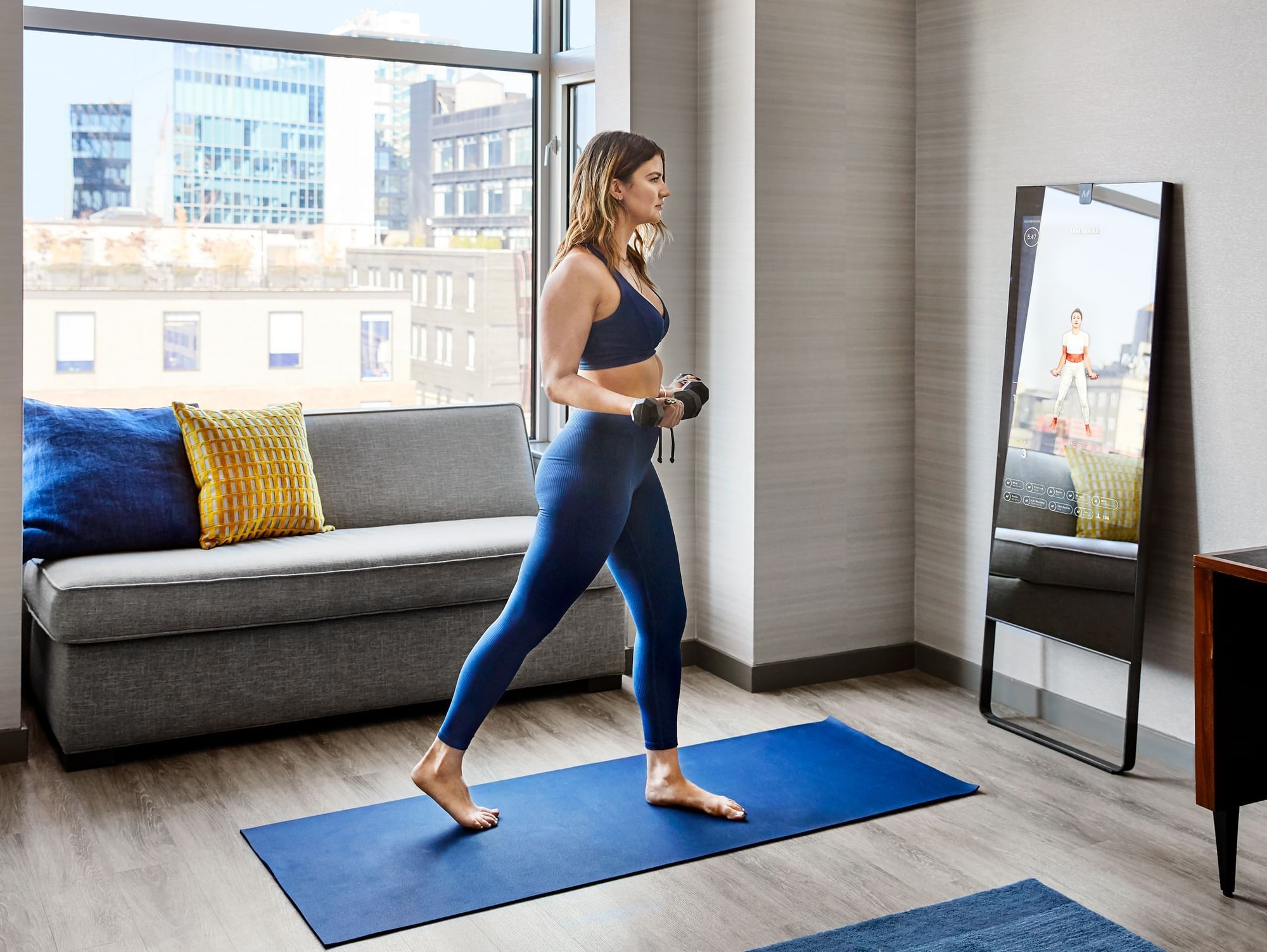 Woman exercising in a hotel room at Gansevoort Meatpacking NYC