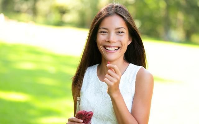 women eating a bowel of raisins 