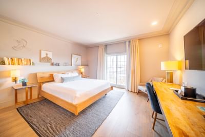 Comfy bed, TV & working table in King Room at Hotel Weyanoke