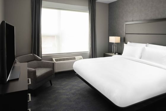 a bed facing a tv in a hotel room