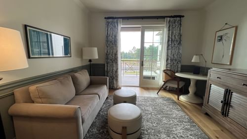 Lounge area with a comfy sofa by the window in Pine Suite at Camp Creek Inn