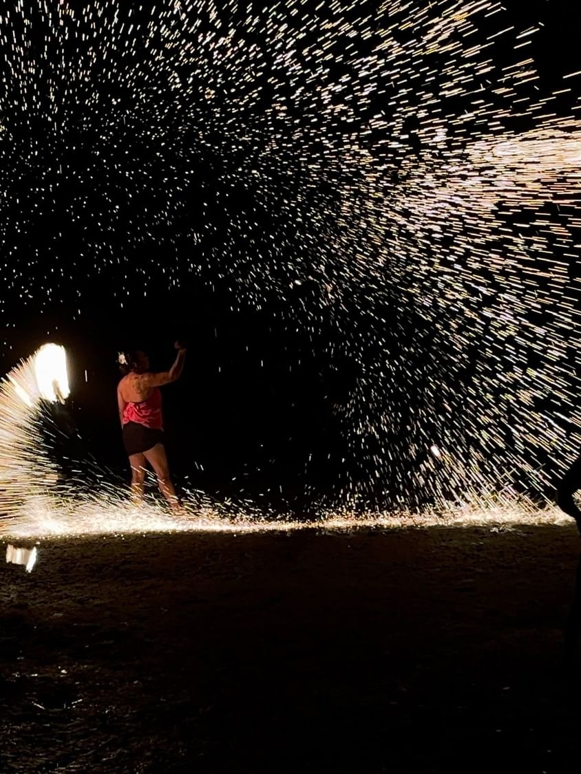 Performer surrounded by sparkling fire during fire dancing at The Naviti Resort Korolevu Fiji