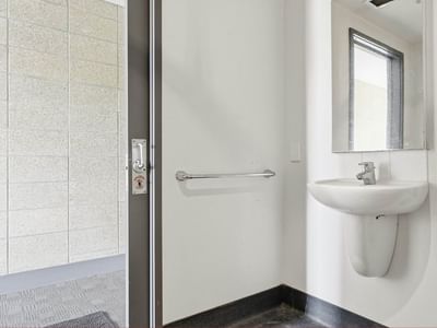 Clean, accessible bathroom with a sink and mirror at Student Living Auckland - Beach.
