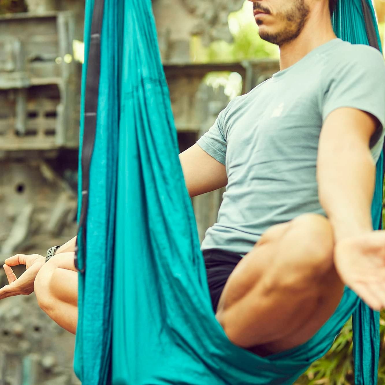 Man practicing yoga on a hammock as part of wellness daily activities at the Marbella Club hotel
