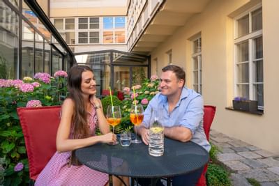 Couple on Terrace with drinks at Hotel Leonardo, Prague 1, Czech