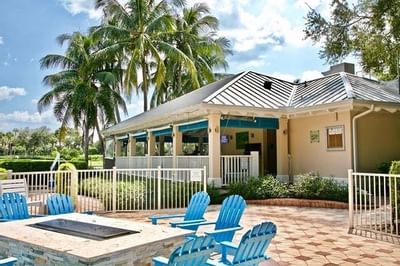 Table with Grill & lounge chairs outdoors at Trianon Bonita Bay