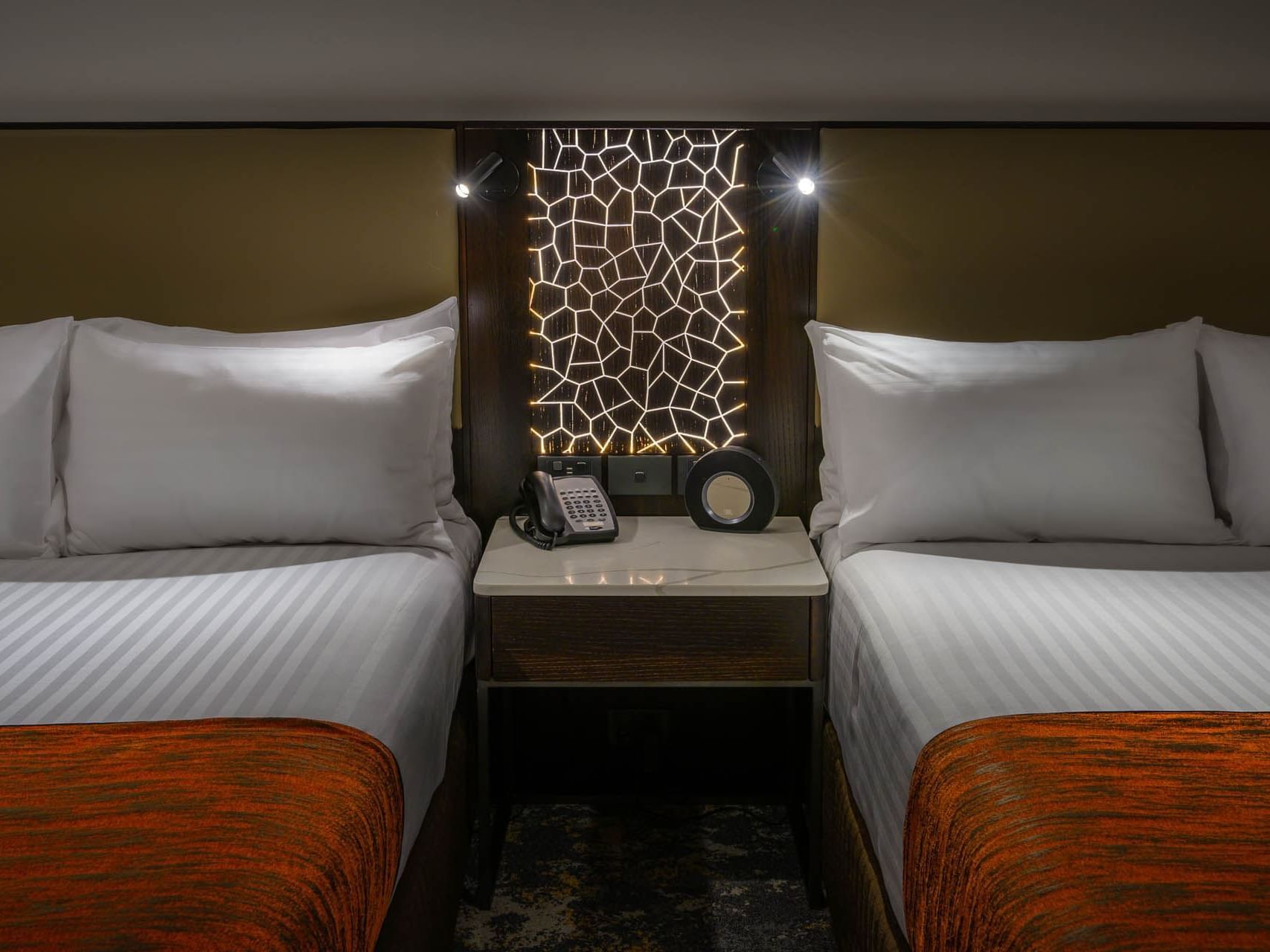 Nightstand by the double beds in a room at Grand Chancellor Hobart