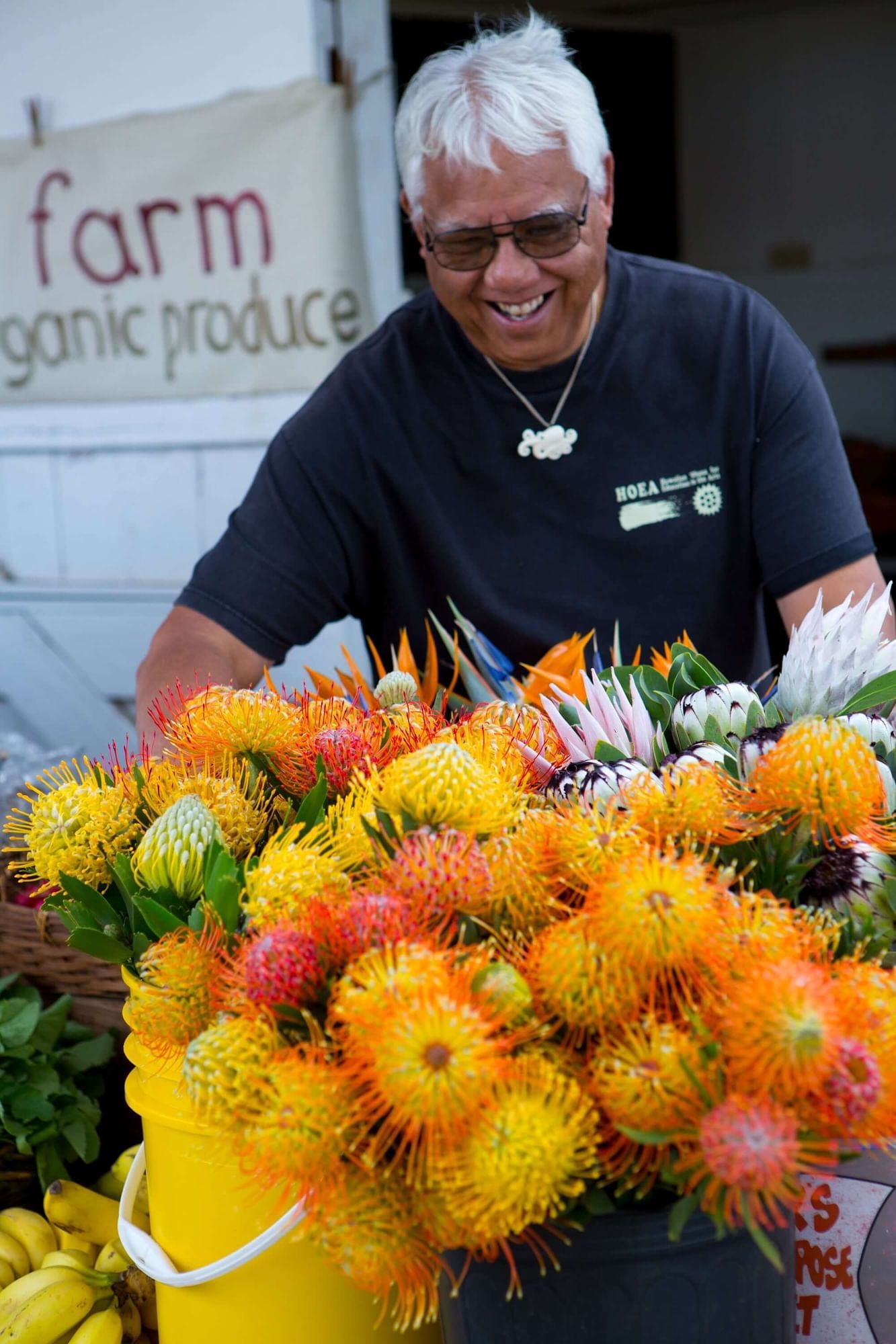 A man picking rambutan in KCC Farmers' Market near Waikiki Resort Hotel