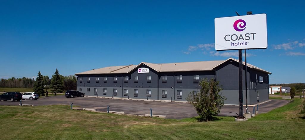 Coast Innisfail Hotel exterior with the Coast Hotels sign and parking lot