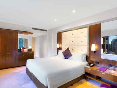 King bed & nightstand in Deluxe Corner at Amora Hotel Sydney