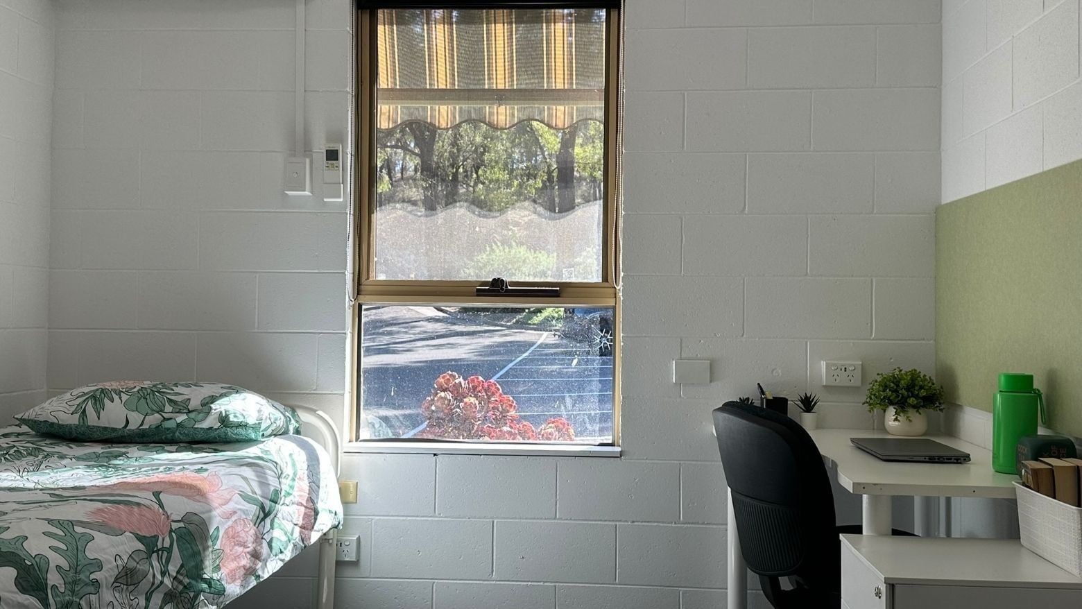 A cozy room with a bed, desk, chair, and window at La Trobe University - Orde House.