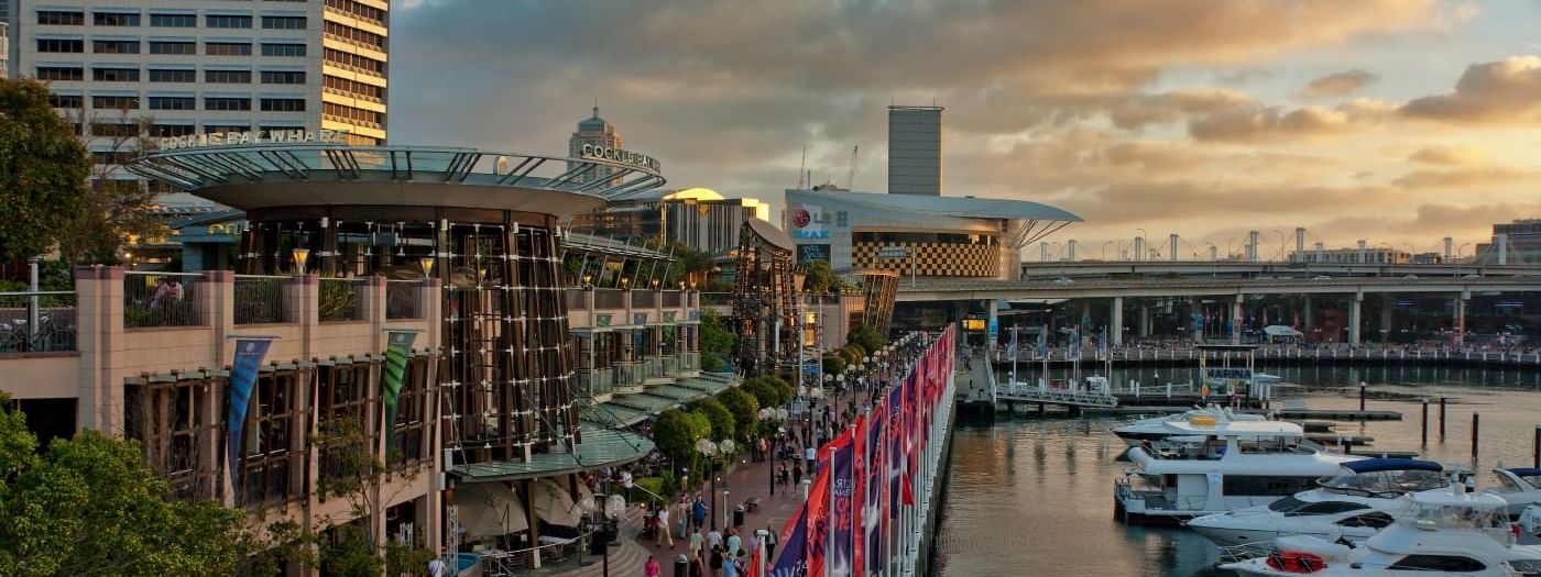 Cockle Bay Wharf at sunset, with boats lining the lively waterfront near Novotel Sydney on Darling Harbour