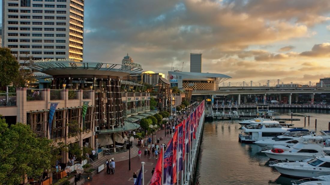 Cockle Bay Wharf at sunset, with boats lining the lively waterfront near Novotel Sydney on Darling Harbour